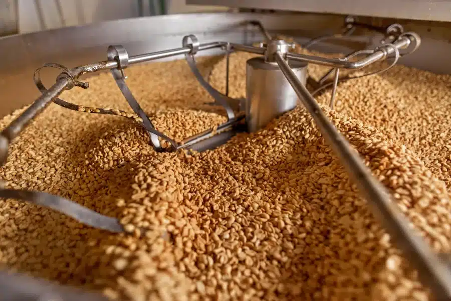 Peanuts being roasted in a plant.