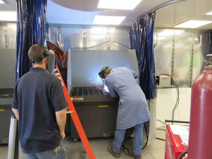 Students working inside Diversitech’s mobile welding trailer